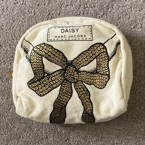 Daisy by Marc Jacobs gold bow cosmetic bag.